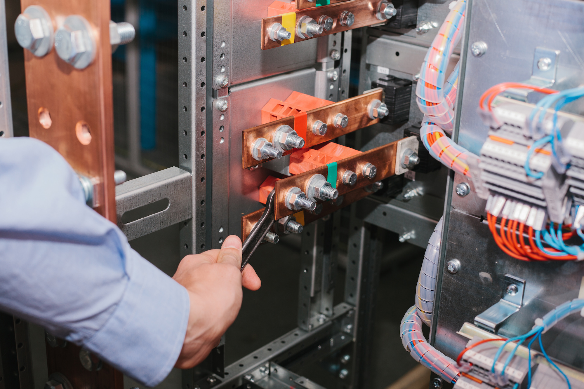 Electrician near the low-voltage cabinet. Uninterrupted power supply. Electricity.