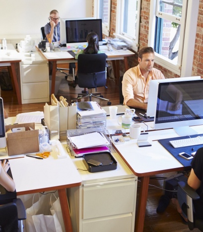 Wide Angle View Of Busy Design Office With Workers At Desks